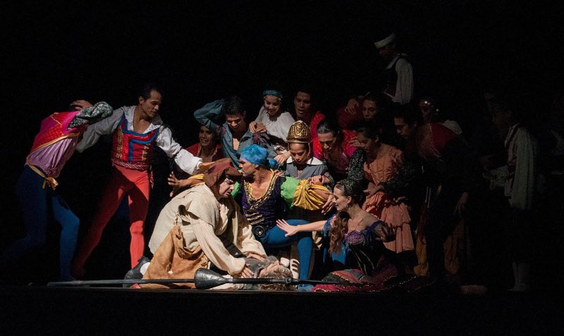 A full company of costumed performers gathered on stage